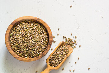 Cannabis seeds at white table top view.