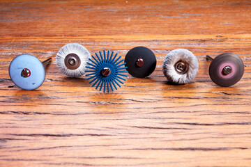 Different goldsmiths tools on the jewelry workplace. Desktop for craft jewelry making with professional tools. Set of tools over rustic wooden background.