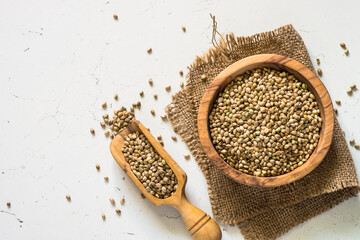 Cannabis seeds at white table top view.
