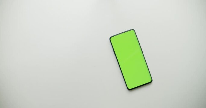 Money and calculator moves avay, then smartphone with green scren appeares, chromakey. Place for advertising. Mobile banking instead of paper currency and old calculator. Commercial packshot concept