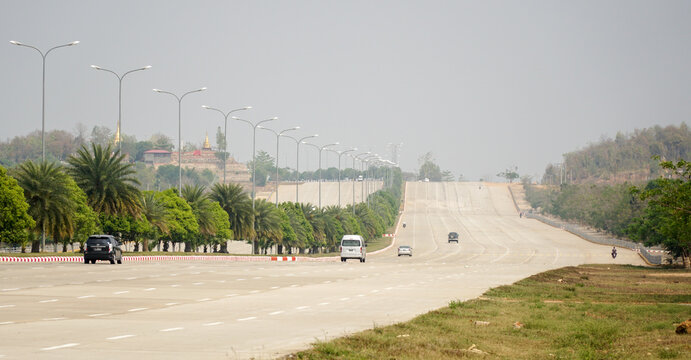 Empty highway road without traffic in Naypyitaw, the planned city capital of Myanmar / Burma.