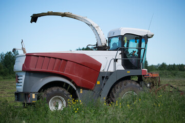 mowing grass with heavy agricultural machinery