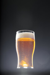 Glass of beer on black background, copy space