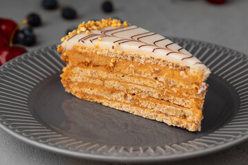 Piece of esterhazi cake decorated with fresh berries