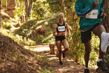 Smiling marathoner running uphill