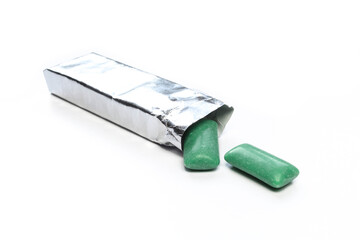 Green chewing gums and bright package isolated on white. Silver paper foil for mint bubblegums