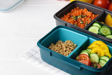 Lunch box with cooked buckwheat and fresh vegetable salad