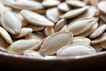 Fresh pumpkin seeds background. Close-up.