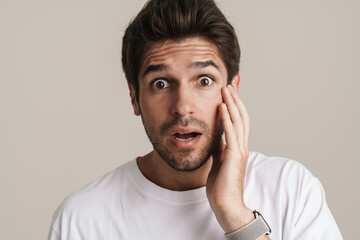 Portrait of shocked young man expressing surprise on camera