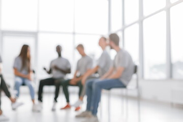 background image of a group of young people at a meeting in a conference room