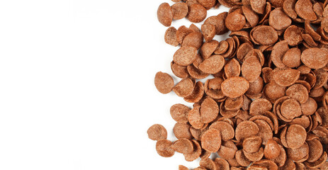 Pile of delicious chocolate cornflakes isolated on white background. Brown crispy flakes ready to eat