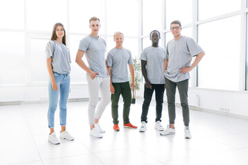 group of young people standing in an empty office.