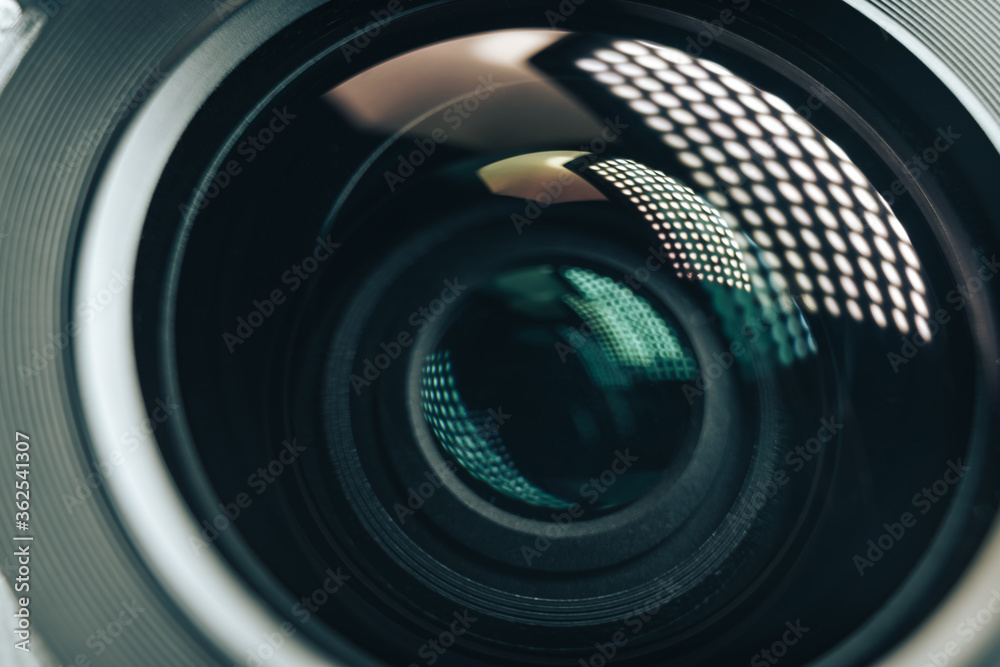 Poster Close up beautiful camera aperture lens with multi colored light glass reflection. Macro view.