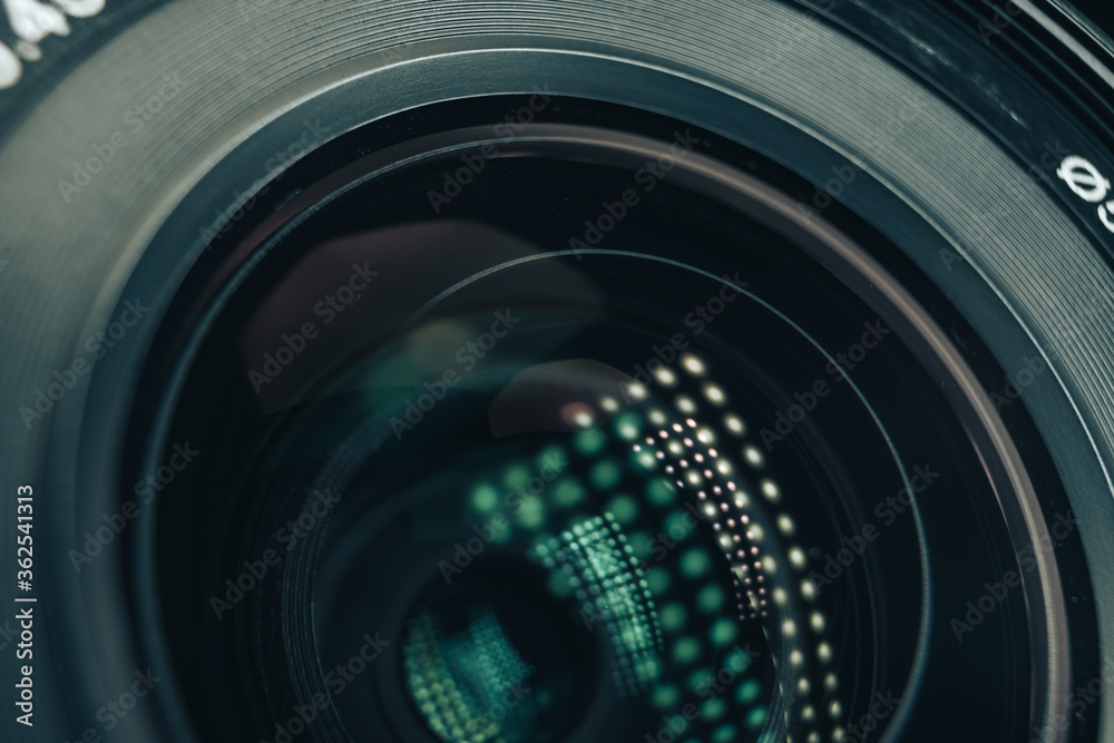 Poster Close up beautiful camera aperture lens with multi colored light glass reflection. Macro view.