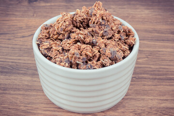 Oat flakes with chocolate in bowl, healthy food for breakfast concept