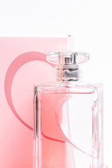 pink perfume bottle in back box on white background copy space. bot view, vertical orientation, close up, mockup