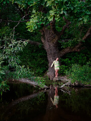 girl by the old oak tree by the lake