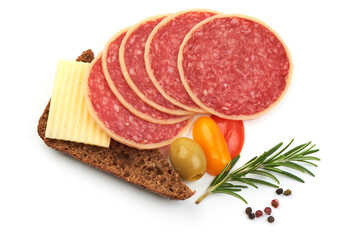 Slices of smoked salami with herbs and spices, isolated on a white background. Close-up.