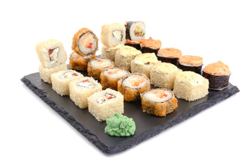 baked sushi in assortment on a stone for serving dishes, white isolated background, horizontal view