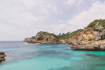 Fototapeta na wymiar Bay at the cliffs with azure blue water. Mediterranean Sea, beautiful nature. 