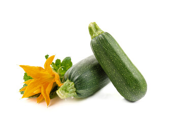 harvest of fresh courgettes with green leaves and flower, isolated on a white background