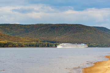 A passenger cruise ship sails on the Volga river near the Zhiguli mountains