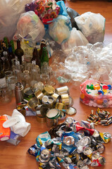 Waste sorting at home. Separate collection of household garbage. Preparation of waste for recycling: glass, plastic bags, metal, plastic, batteries, aluminum. Waste management concept.