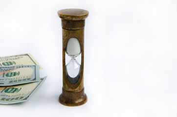 Hourglass and American dollars on a white background
