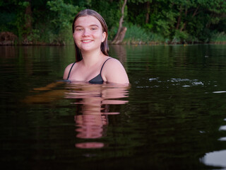 Fototapeta premium mermaid girl in the water among water lilies at sunset