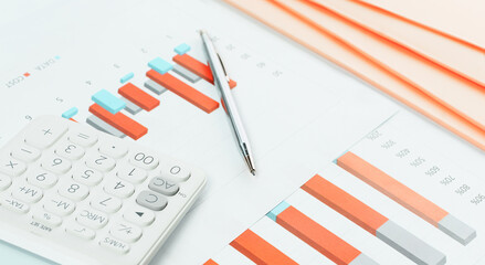 Finance and business concept. White calculator on financial graphs on office desk, paperwork folders. Accounting budgeting or market analysis. Web banner . Minimal white and orange