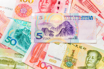Renminbi official currency of China. Abbreviation RMB. Yuan basic unit of the renminbi. Set of one hundred, one, five, and fifty yuan close up. Paper bills. Chinese money. Business concept.