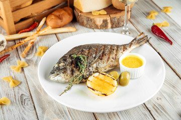 Grilled sea dorado fish with lemon creamy sauce