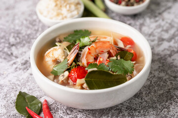 Food and drink, traditional Thai cuisine. Spicy tom yam kung, tom yum sour soup with shrimp, prawn, coconut milk, lemongrass and chili pepper in a bowl