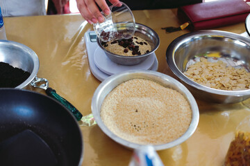 weighing sesame seed for making cereal granula muesli bar