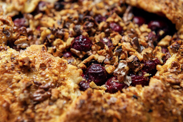 Close-up filling of cherries and walnuts for galette. Open pie filling texture.