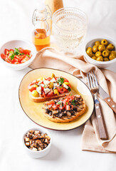 Delicious bruschettas with mushrooms, blue cheese, olives and tomatoes