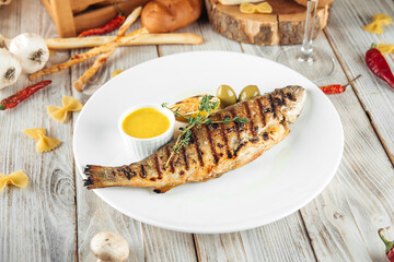 Grilled river trout fish with lemon cream sauce