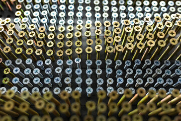 Obraz premium gold and silver nails hanging neatly on a building shop window