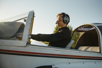 Young woman and pilot in in the cockpit of a plane. Front view © Serhii