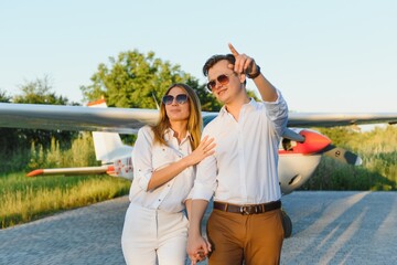 Couple in love hugging near private plane. Selective focus