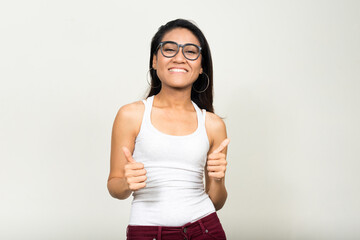 Portrait of happy Asian nerd woman giving thumbs up