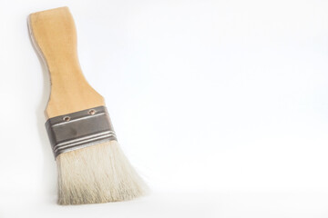 Old wooden handle brush on dirty ground