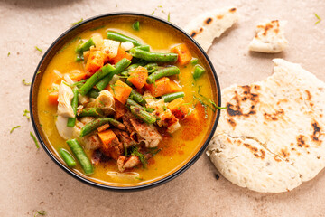 Indian or Thai Curry Soup Served in Bowl with Fresh Beans