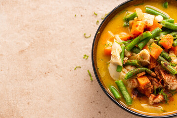 Indian or Thai Curry Soup Served in Bowl with Fresh Beans