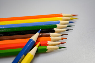 Fototapeta premium colored pencils with notebook for drawing on paper and fun