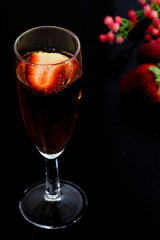 A glass of rose wine with strawberries