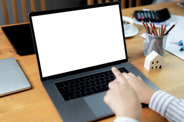 Computer mockup white background on desk. Laptop with blank white screen.