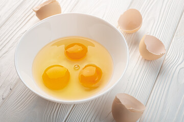 Eggs chopped in a bowl and shell on a table