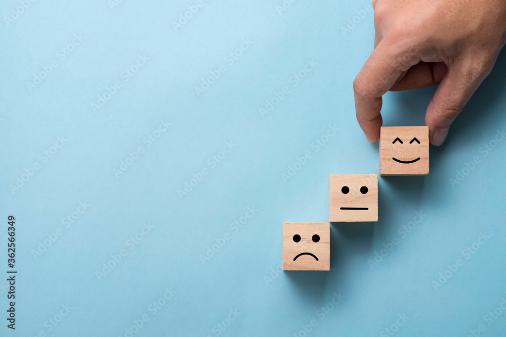 Poster hand putting smile emotion face to above normal and sadness mood for customer satisfaction and evalu