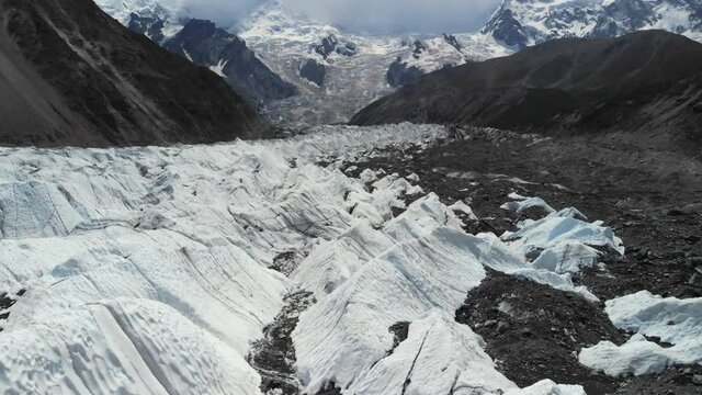 Stunning view of the Rakhiot morraine glacier, composed of ice and rocks, coming from the Nanga Parbat mountain, view near the base camp, popular trekking destination in Pakistan